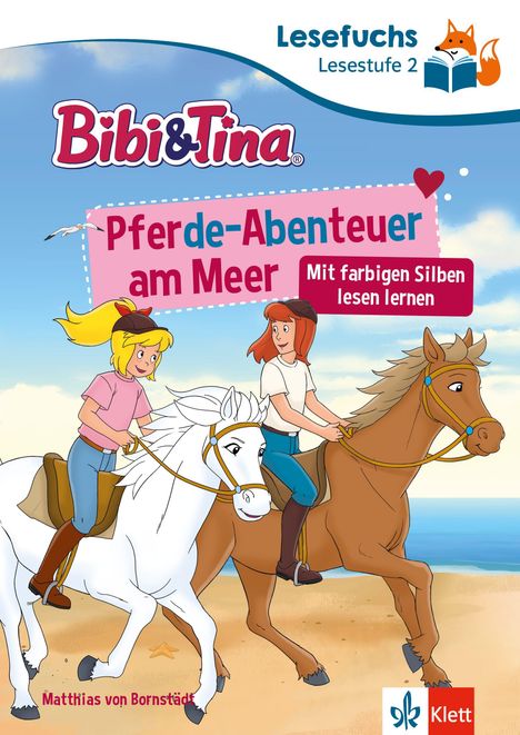 "Pferde-Abenteuer am Meer", "Mit farbigen Silben lesen lernen". Zwei Mädchen reiten am Strand.