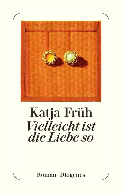 "Katja Früh. Vielleicht ist die Liebe so. Roman Diogenes." zeigt zwei goldene Ohrringe auf orangefarbigem Hintergrund.