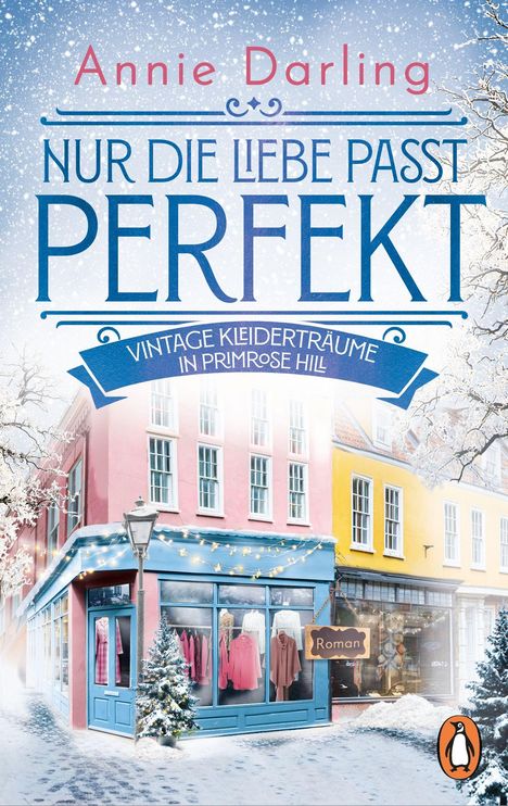 Text: "Annie Darling", "Nur die Liebe passt perfekt", "Vintage Kleiderträume in Primrose Hill", "Roman". Winterliche Straßenszene mit schneebedeckten Gebäuden und Schaufenstern voller Kleidung.