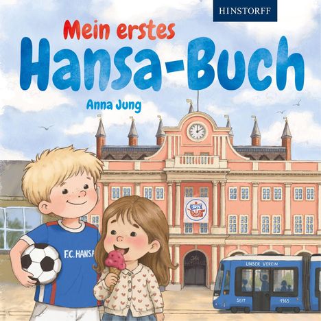 "Mein erstes Hansa-Buch", "Anna Jung". Zwei Kinder, ein Junge mit Fußballtrikot, ein Mädchen mit Eis, vor einem Rathaus.