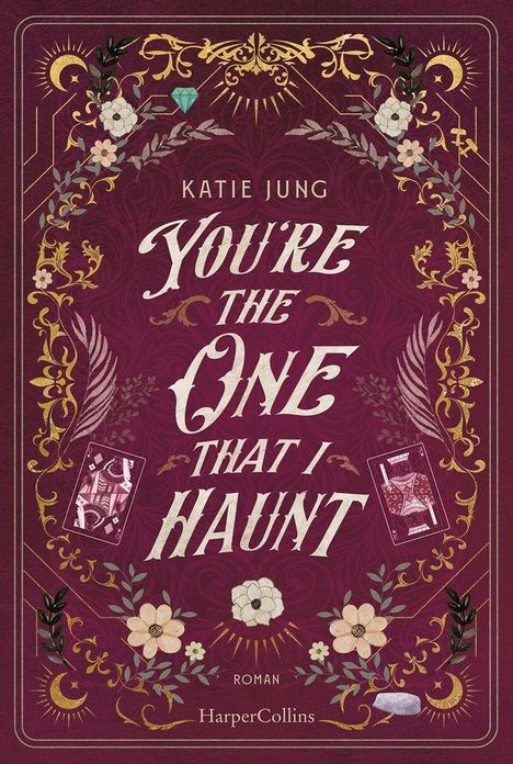 Buchcover mit dem Titel "You’re the One That I Haunt" von Katie Jung. Florale Verzierungen und mystische Symbole.