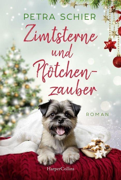 "Zimtsterne und Pfötchenzauber" von Petra Schier. Fröhlicher Hund vor Weihnachtsbaum mit Zimtsternen auf rotem Tuch.