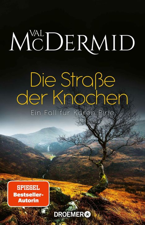 "Val McDermid. Die Straße der Knochen. Ein Fall für Karen Pirie. SPIEGEL Bestseller-Autorin. Droemer."  
Eine herbstliche Hügellandschaft.