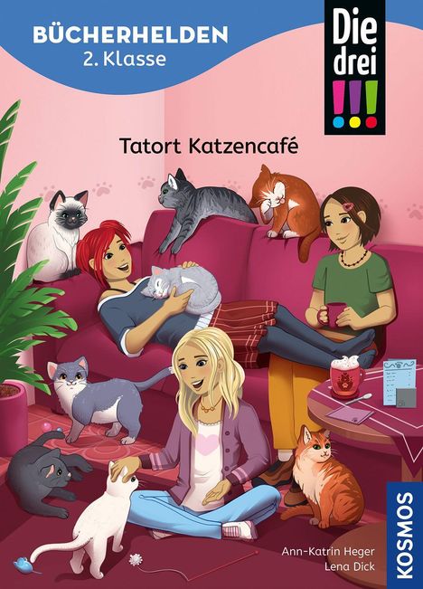 Text: "Tatort Katzencafé", "BÜCHERHELDEN 2. Klasse", "Die drei !!!". Drei Mädchen auf einem Sofa umgeben von Katzen.