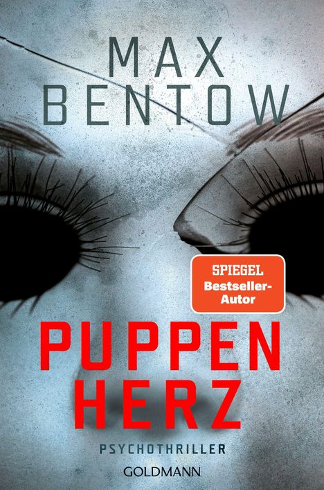 Der Text „Puppen Herz“ steht in Rot unter puppenartigen Gesichtszügen mit dunklen Augenhöhlen und langen Wimpern.