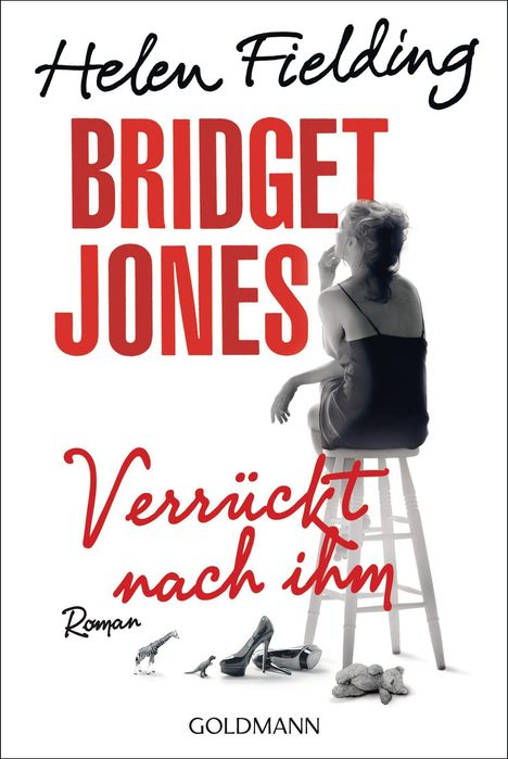 "Bridget Jones Verrückt nach ihm Roman" in kräftigem Schriftbild. Frau sitzt gedankenverloren auf einem Hocker, Spielzeug und Schuhe.