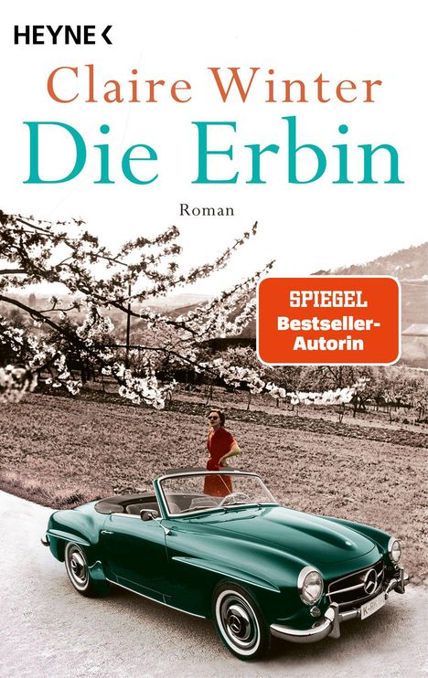 Titel: Claire Winter - Die Erbin. Roman. SPIEGEL Bestseller-Autorin. Frau und Cabrio vor blühendem Baum.