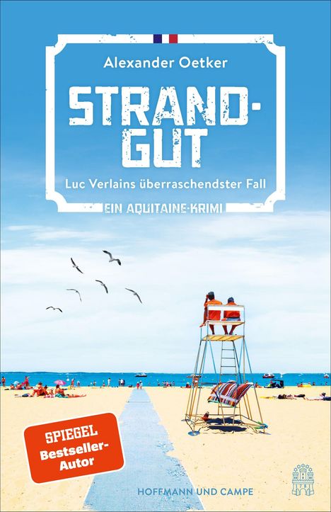 Cover mit dem Text: "Alexander Oetker, STRANDGUT, Luc Verlains überraschendster Fall, Ein Aquitaine-Krimi." Strandmotiv mit Liegestuhl.