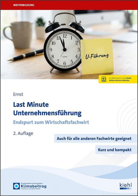 „Last Minute Unternehmensführung. Endspurt zum Wirtschaftsfachwirt“. Wecker mit Notiz „U-Führung“ auf Holzschreibtisch.