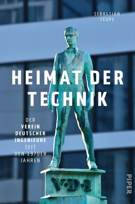 "Heimat der Technik" von Sebastian Teupe. Bronzestatue vor modernem Gebäude. Auf der Plakette steht "VDI".
