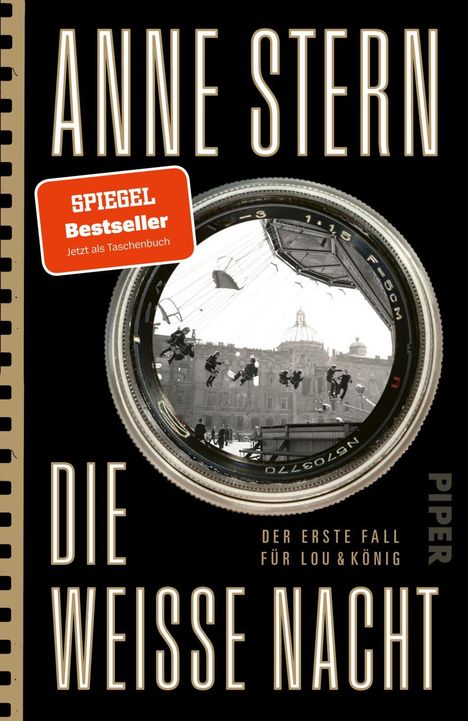 "SPIEGEL Bestseller", "Anne Stern", "Die weisse Nacht", "Der erste Fall für Lou & König". Kameralinse mit Karussellszene.
