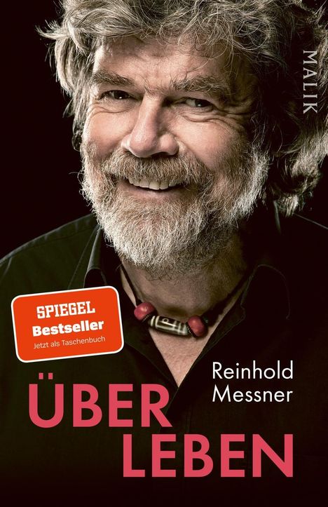 "Über Leben", Reinhold Messner, Spiegel Bestseller. Ein Mann mit Bart lächelt, trägt eine Halskette.