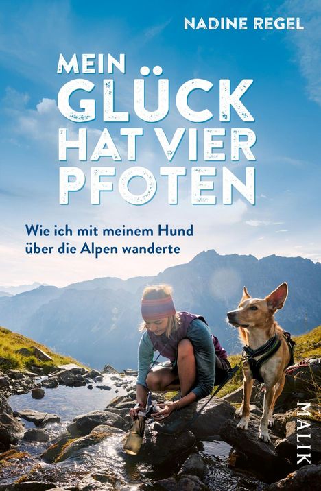 Titel: "Mein Glück hat vier Pfoten". Untertitel: "Wie ich mit meinem Hund über die Alpen wanderte". Frau mit Hund an Bach.