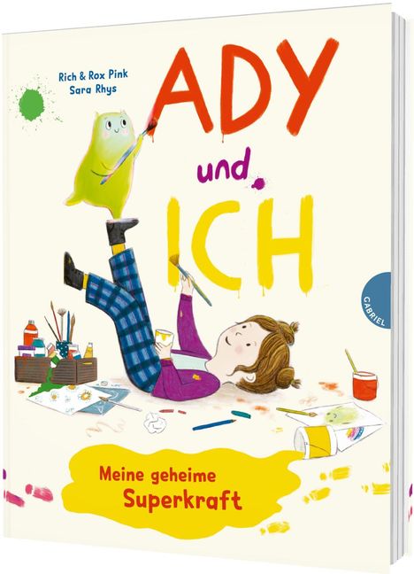 „ADY und ICH“ in großen bunten Buchstaben. Illustration: Kind liegt auf dem Boden, malt, kleine Kreatur malt auch.