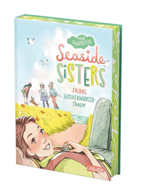 „Seaside Sisters: Fridas Wolkenwunschtraum“ auf Pastellbuchcover mit Mädchen in Wiese, Meer und Freundinnen im Hintergrund.