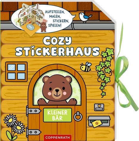 „Aufstellen, Malen, Stickern, Spielen!“ sagt der Vogel. „Cozy Stickerhaus“ steht auf dem Holzhaus mit kleinem Bär.