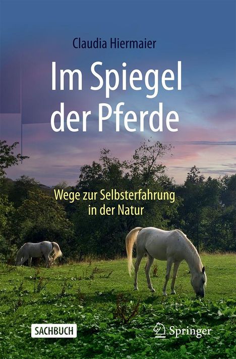 Buchtitel: "Im Spiegel der Pferde". Untertitel: "Wege zur Selbsterfahrung in der Natur". Zwei Pferde auf einer Wiese bei Sonnenuntergang.