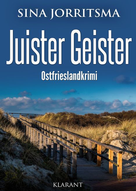 „Juister Geister: Ostfrieslandkrimi“ von Sina Jorritsma. Ein Holzweg führt durch Dünen unter blauem Himmel.