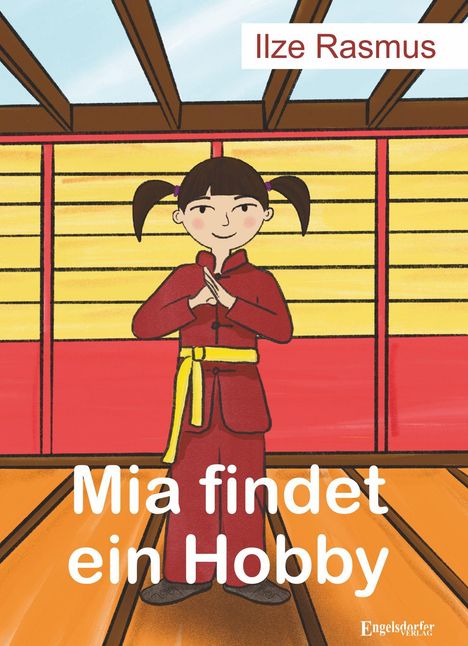 „Ilze Rasmus“ oben, „Mia findet ein Hobby“ unten. Illustration eines Mädchens in Karatekleidung, lächelnd in einem Dojo.