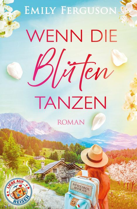 "Wenn die Blüten tanzen, Roman". Eine Frau mit Hut sieht ein alpines Tal mit Hütte und blühenden Bäumen.