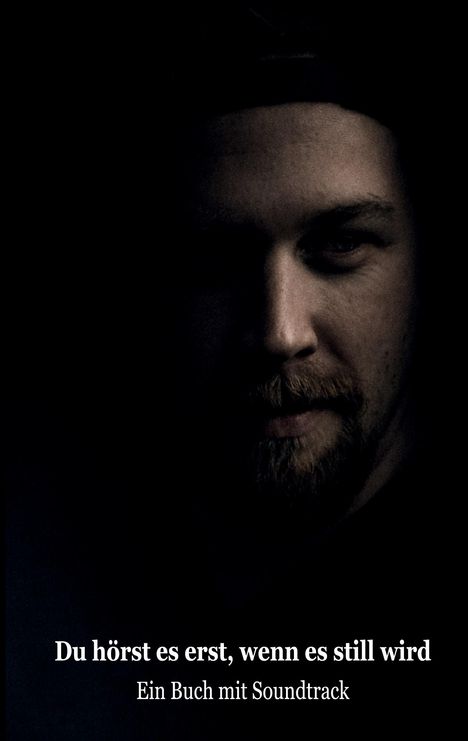 „Du hörst es erst, wenn es still wird. Ein Buch mit Soundtrack.“ Dunkles Porträt eines Mannes, nur halb beleuchtet.