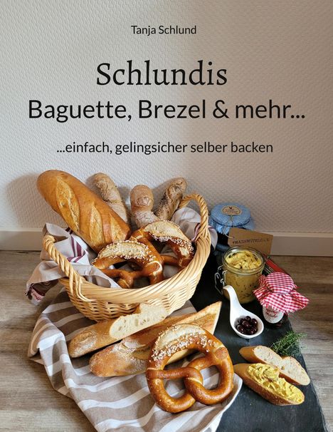 „Schlundis – Baguette, Brezel & mehr… einfach, gelingsicher selber backen“ steht über einem Korb voller Gebäck.