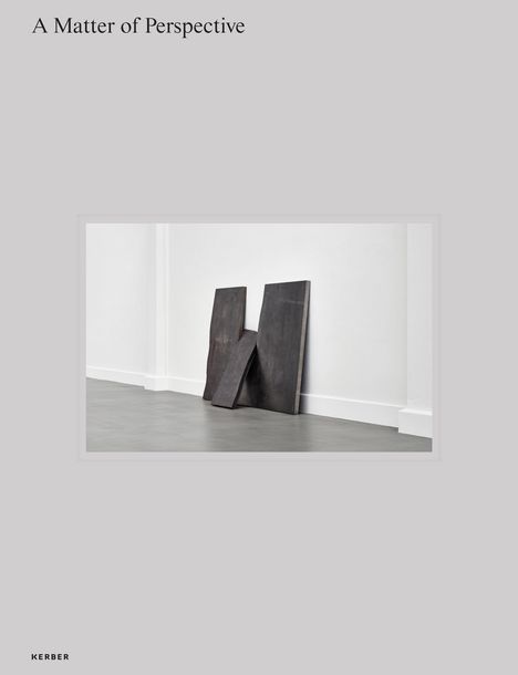 Text: "A Matter of Perspective". Unten links "KERBER". Zwei dunkle Platten lehnen an einer weißen Wand.