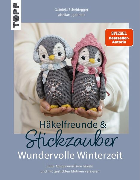 Texte: "Gabriela Scheidegger", "@bellart_gabriela", "SPIEGEL Bestseller-Autorin", "Häkelfreunde & Stickzauber: Wundervolle Winterzeit". Zwei gehäkelte Pinguine.