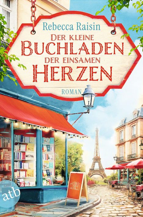 Ein hängendes Schild mit der Aufschrift: "Der kleine Buchladen der einsamen Herzen" vor einem Pariser Straßencafé.