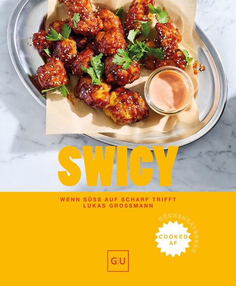 "SWICY" in großen Buchstaben. Darunter "WENN SÜSS AUF SCHARF TRIFFT" von LUKAS GROSSMANN. Oben knusprige Chicken Wings mit Sauce.
