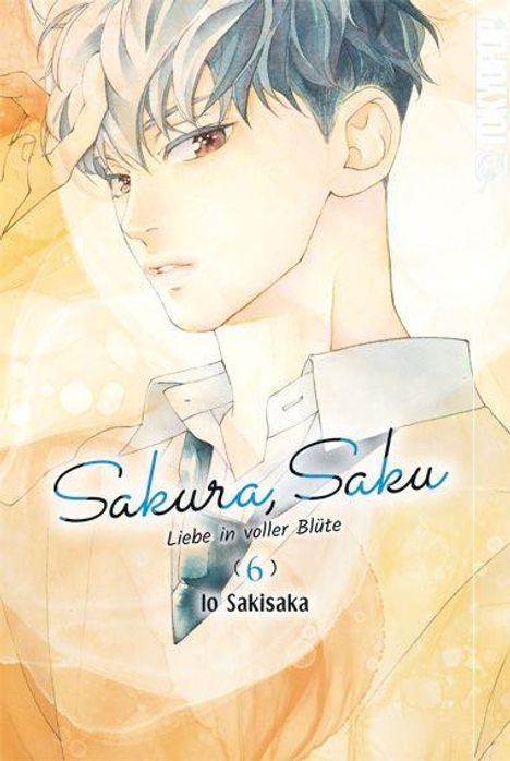 "Sakura, Saku: Liebe in voller Blüte - Io Sakisaka." Illustration eines Jungen mit hellem Hemd und blau-weißem Haar.