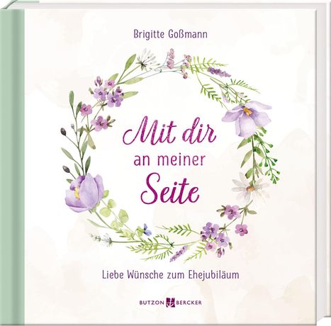 „Mit dir an meiner Seite“ in lila Schrift, von Blumenkranz umgeben. Darunter „Liebe Wünsche zum Ehejubiläum“. Autor: Brigitte Goßmann.