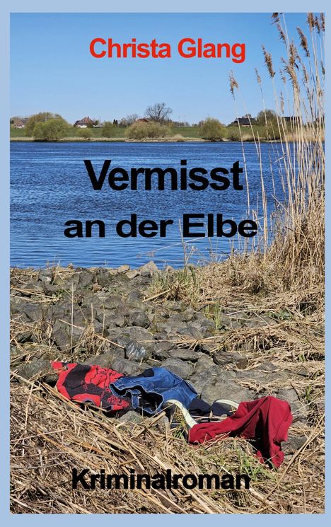 "Vermisst an der Elbe" von Christa Glang. Krimi-Roman. Ufer mit Kleidung, Fluss und Schilf im Hintergrund.