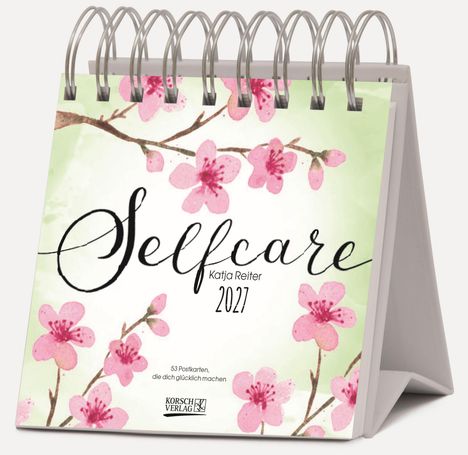 "Selfcare, Katja Reiter, 2027." Rosafarbene Blüten auf einem Zweig auf einem Aufstellkalender.