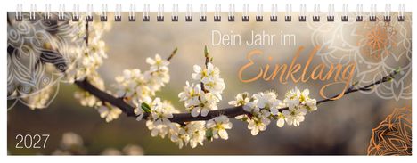 "Dein Jahr im Einklang", 2027. Ein Zweig mit weißen Blüten und dekorativen Mustern im Hintergrund.