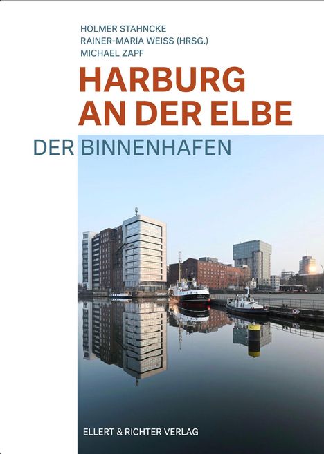 Text: HARBOURG AN DER ELBE, DER BINNENHAFEN. Hafen mit Gebäuden am Wasser im Hintergrund.