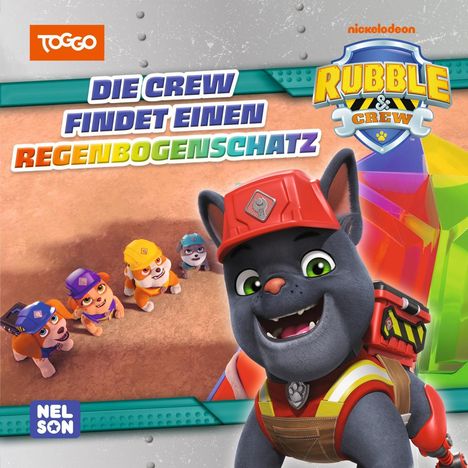 Text: "Die Crew findet einen Regenbogenschatz." Fünf fröhliche Welpen; einer trägt einen roten Bauhelm. Logo oben rechts.