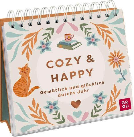 "COZY & HAPPY, Gemütlich und glücklich durchs Jahr." Illustration mit Katze, Blättern, Blumen und einer Teetasse auf Büchern.