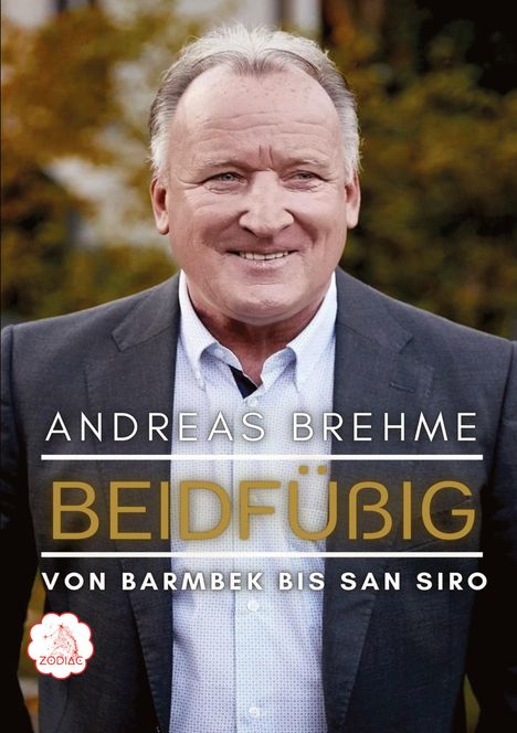 "Andreas Brehme: Beidfüßig - Von Barmbek bis San Siro". Fröhlicher Mann im Anzug, Hintergrund in warmen Farben. ZODIAC-Logo.