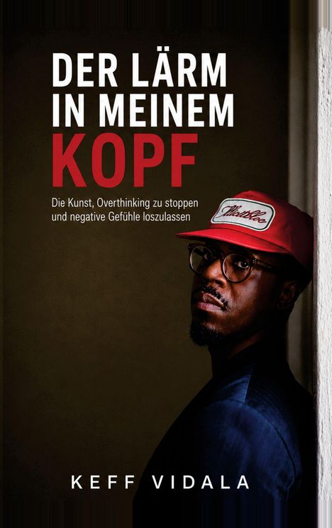 Der Text: "DER LÄRM IN MEINEM KOPF" und "KEFF VIDALA". Ein Mann mit Brille und roter Mütze steht an einer Wand.