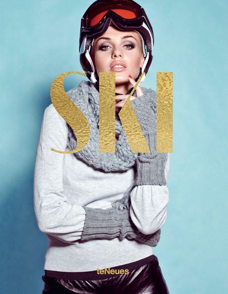 "SKI" steht in großen goldenen Buchstaben. Eine Frau mit Skibrille und Winterkleidung vor einem blauen Hintergrund.