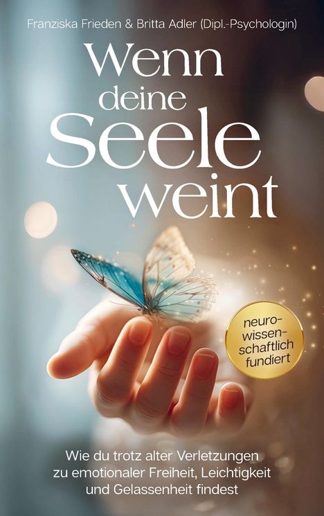 Ein Schmetterling sitzt auf einer Hand vor einem verschwommenen Hintergrund. Texte: "Wenn deine Seele weint".