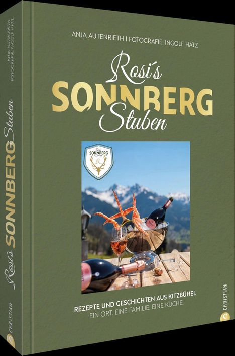 Auf dem Cover steht: "Rosi's Sonnberg Stuben". Darunter eine Flasche Wein mit Gläsern vor Alpenkulisse.