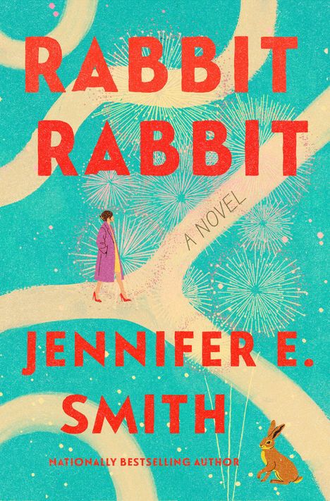 Text: "RABBIT RABBIT", "A NOVEL", "JENNIFER E. SMITH". Eine Frau spaziert auf einem Pfad, umgeben von Feuerwerkskörpern.