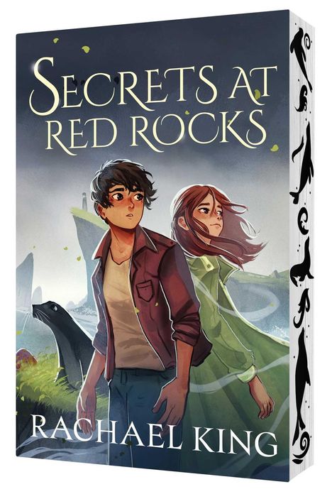 „SECRETS AT RED ROCKS“ und „RACHAEL KING“. Zwei Figuren blicken aufmerksam, eine Robbe im Vordergrund.