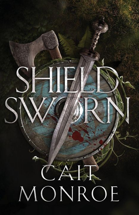 Text: "SHIELD SWORN" und "CAIT MONROE". Axt und Schwert ruhen auf einem blutbefleckten, grünen Schild mit Farnen.