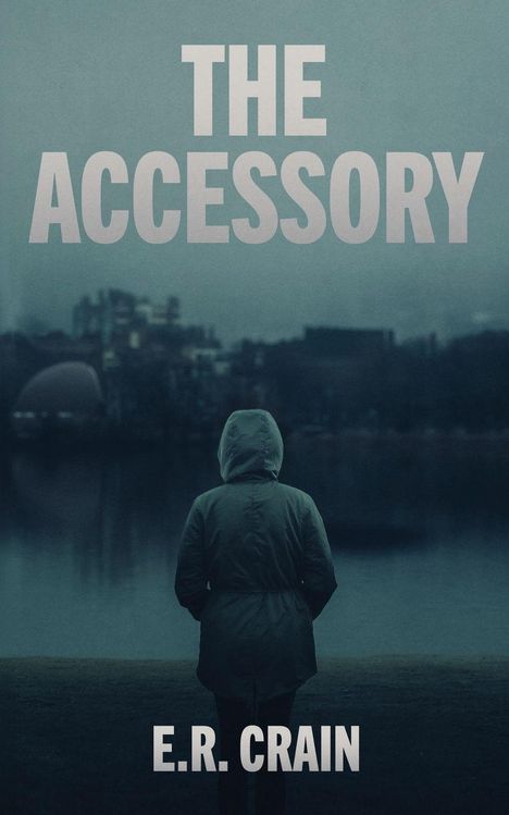 Text: "THE ACCESSORY" und "E.R. CRAIN". Eine Person mit Kapuze steht vor einem nebligen See.