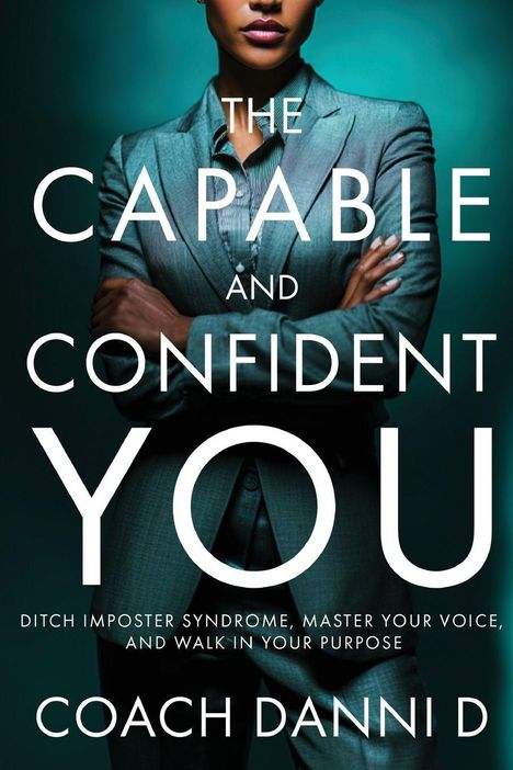 „The Capable and Confident You“ von Coach Danni D. Frau in Anzug mit verschränkten Armen vor grünem Hintergrund.