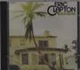 "ERIC CLAPTON 461 OCEAN BOULEVARD" steht oben rechts. Ein Haus mit Palmen und eine Person lehnt an einem Baum.