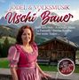 Jodel & Volksmusik mit Uschi Bauer. Titel: Hand aufs Herz, A richtiger Mann. Frau im Dirndl vor Almhütte, Berge im Hintergrund.
